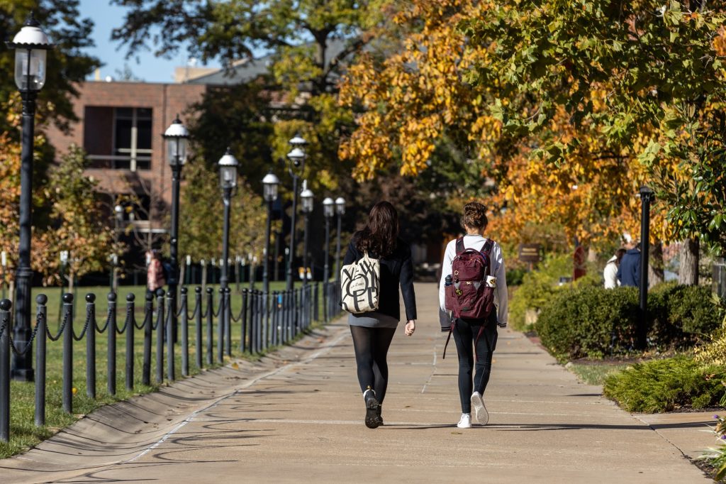 Two students walking on campus.