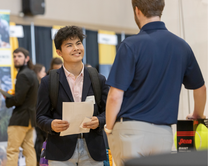 Student talking to potential future employer.