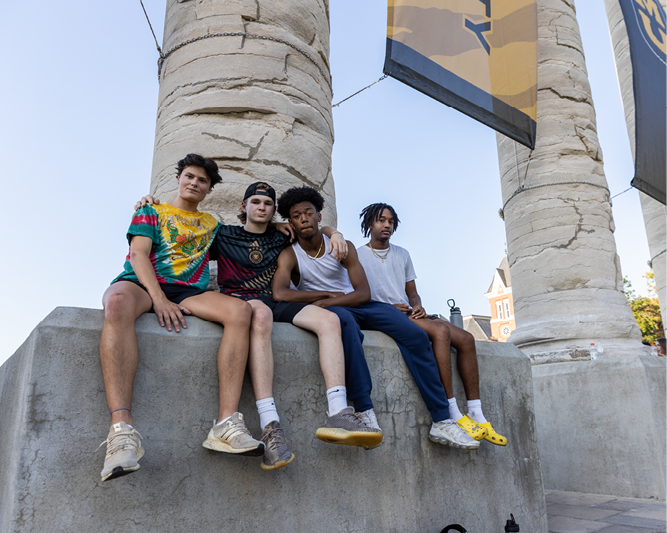 Students sitting on the columns.