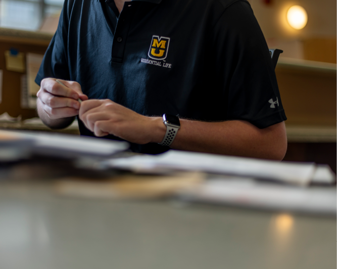Student working at front desk.