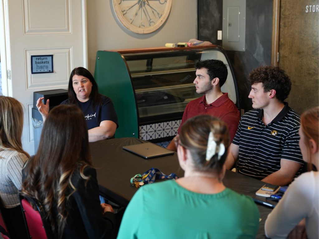 students in a Community Engaged Learning class speaking with a local business owner