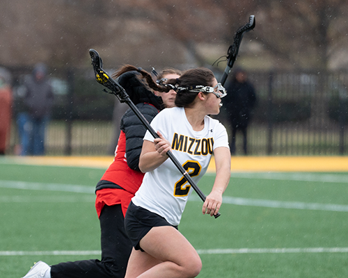 Students competing in Lacrosse match.