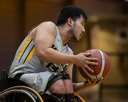 Wheelchair Basketball player on court.