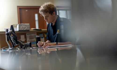 Student working at front desk.