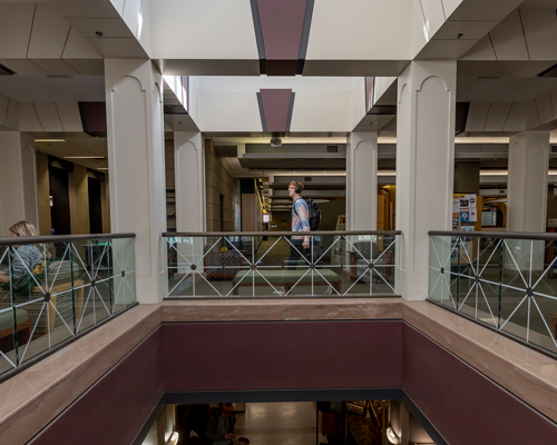 Student walking in library.