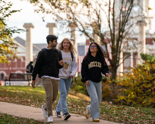 Students walking on campus during fall.