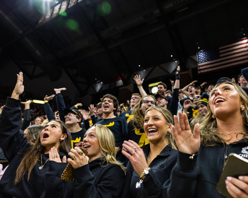 Students cheering at sport event.
