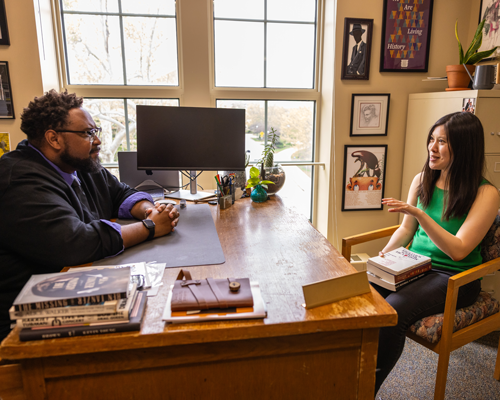 Advisor talking to student.