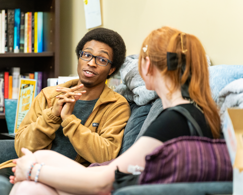 Students talking on couch.