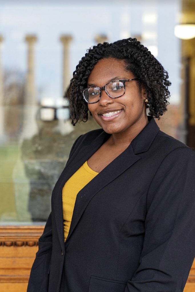 Nadia Gresham smiles in front of Jesse Hall.