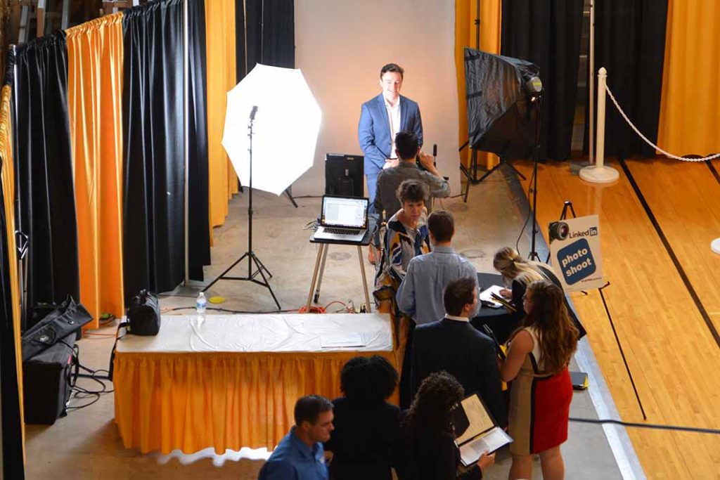 Overhead view of students standing in line for professional headshots.