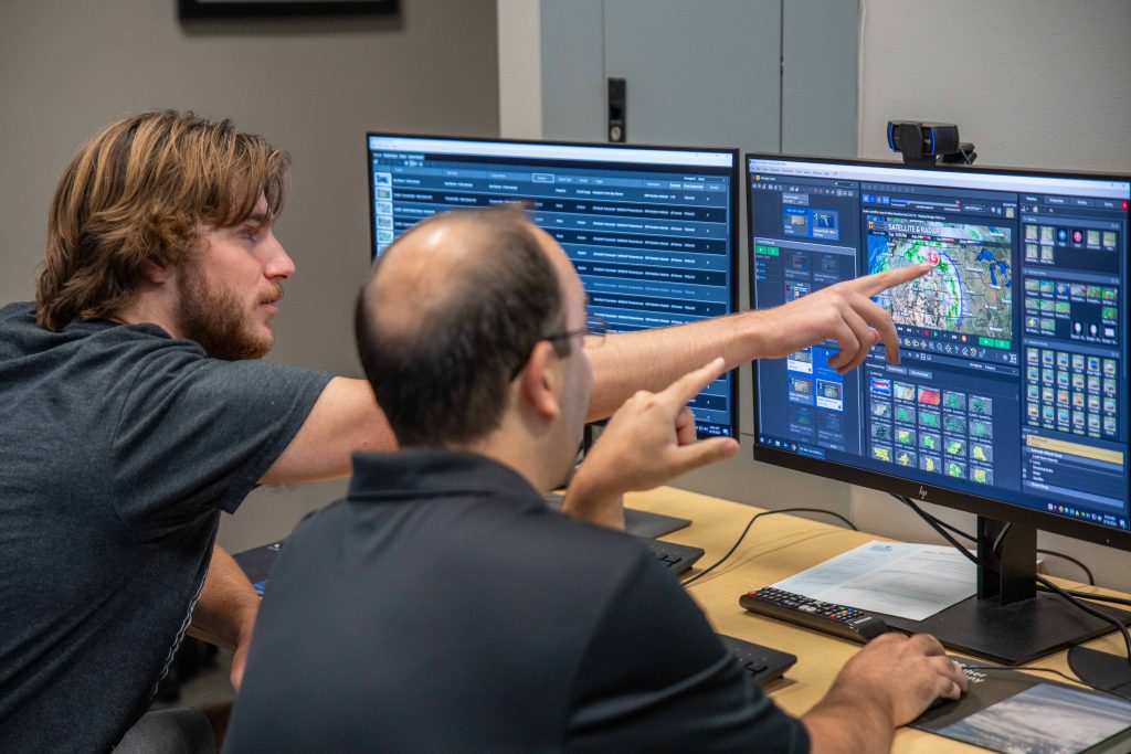 Undergraduate and graduate students working on the university’s daily forecast in the WAV Lab, led by Eric Aldrich at the Anheuser Busch Natural Resources building.