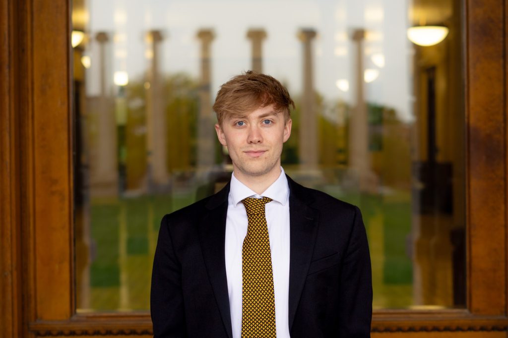 Jackson Wiley stands in front of Jesse Hall for a photo.