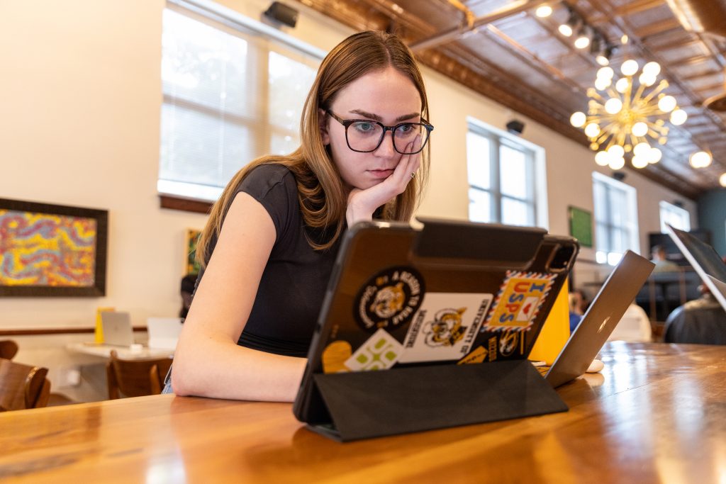 Student focused looking at laptop.
