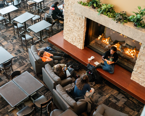 Students sitting by fire.