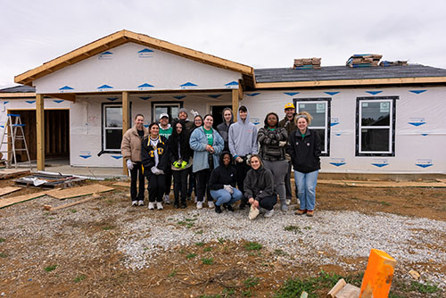 Students in front of house they built for Habitat for Humanity.