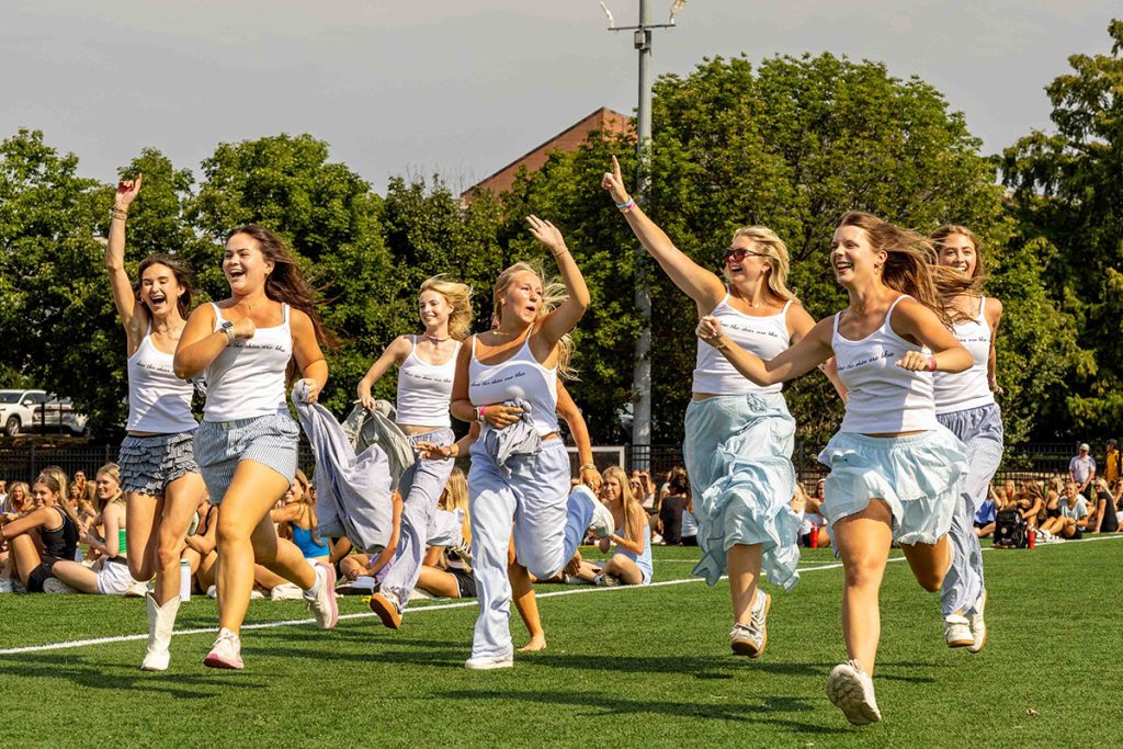 Sorority members running to their house on bid day.