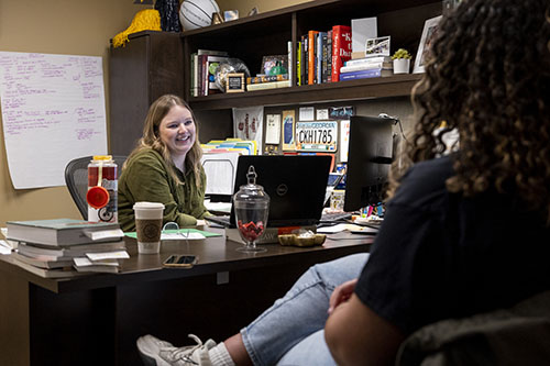 Student and Care Team member talking in office.