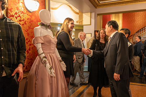 President Choi at the Chancellor's Art Showcase viewing a student's display.