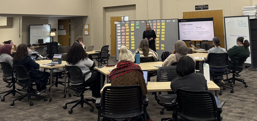 Students gathered together listening to speaker in the Student Success Center. 